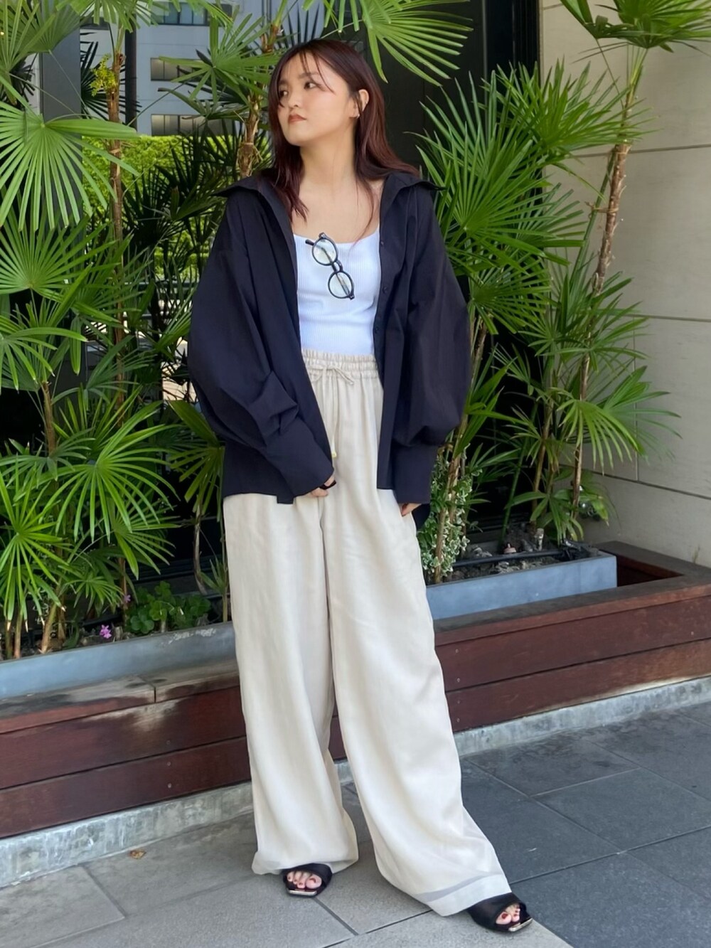 ホワイト系のタンクトップ、ホワイト系のその他パンツ、ブラック系のサンダルを着用したレディースの夏コーディネートの2枚目の写真