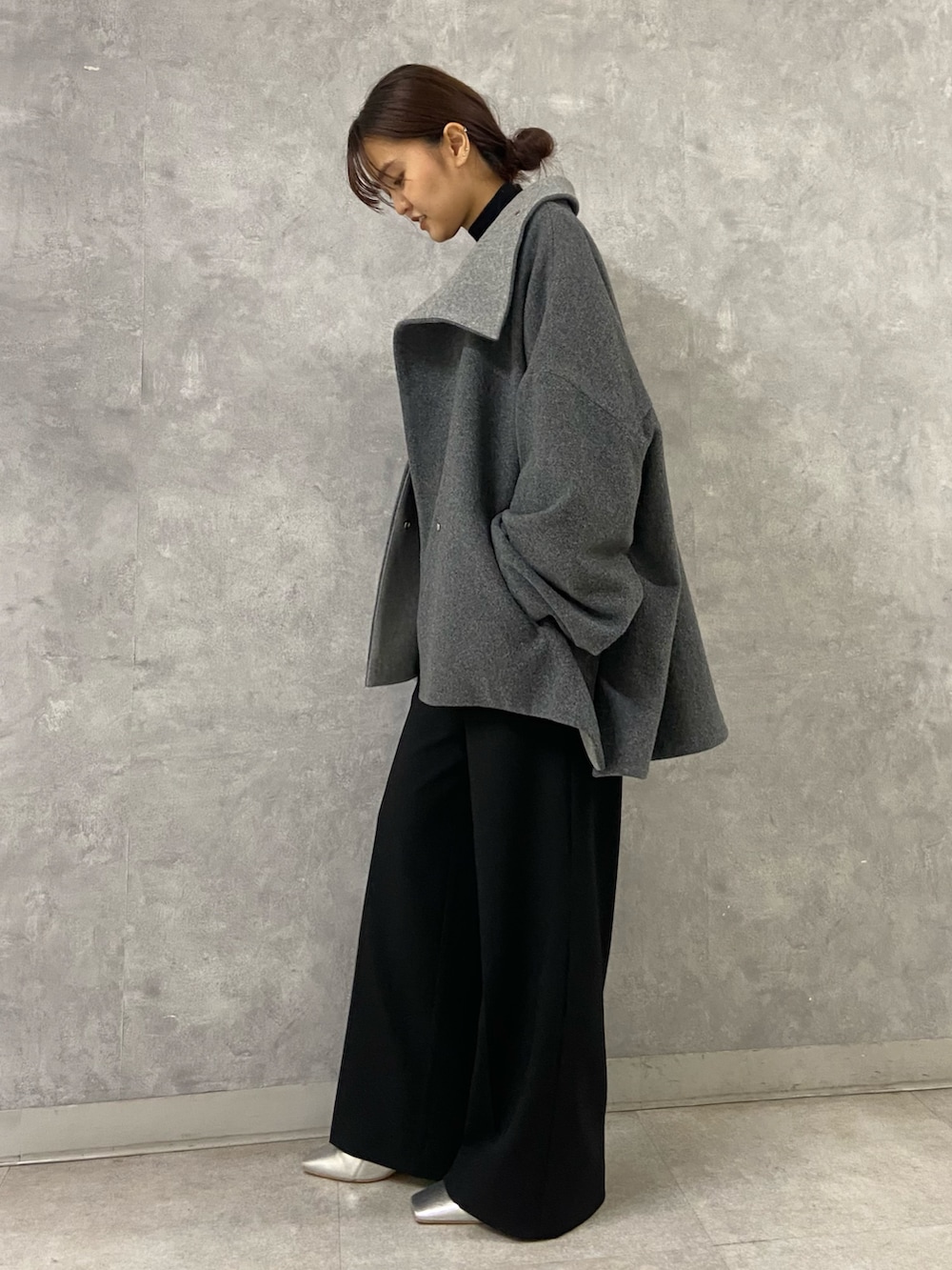 ブラック系のその他パンツ、シルバー系のブーツ、グレー系のその他アウターを着用したレディースの冬コーディネートの2枚目の写真