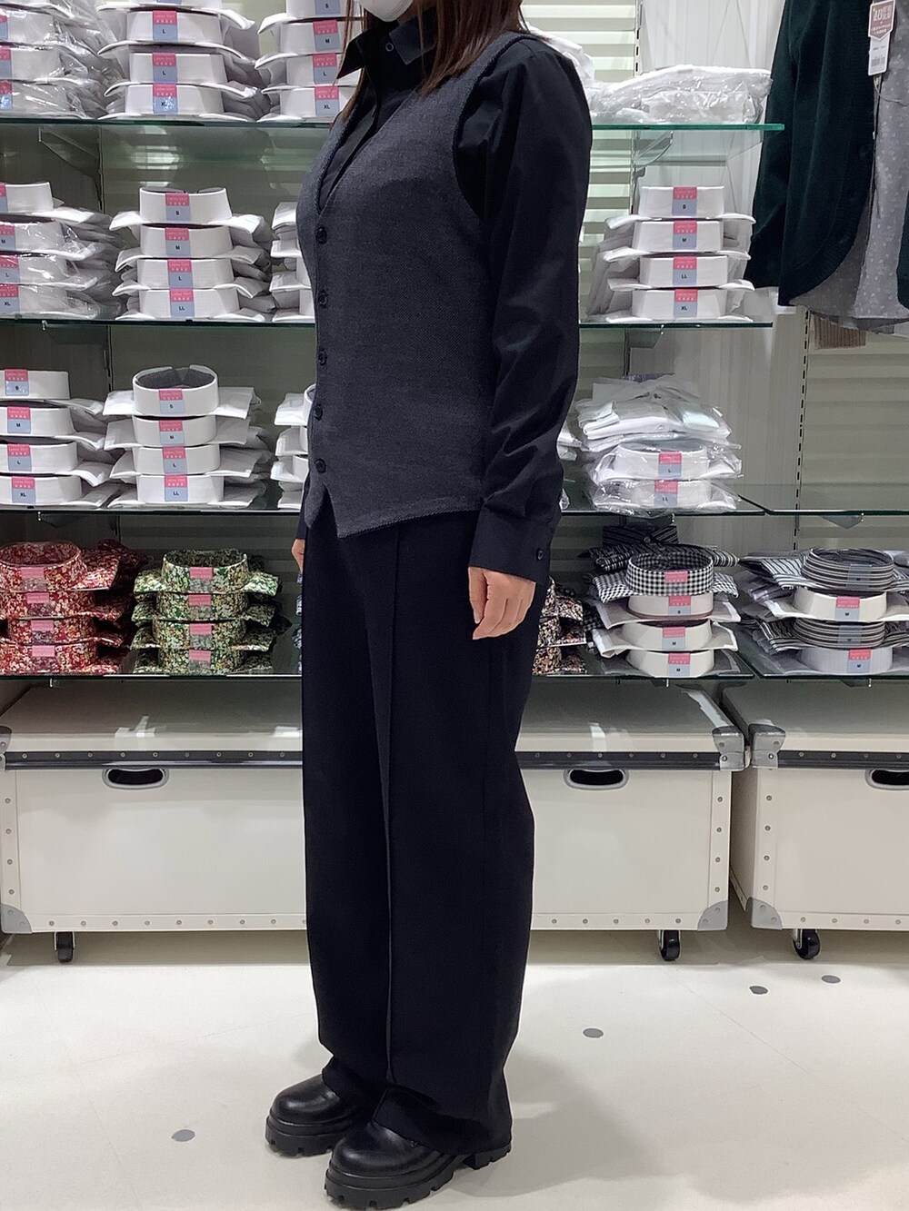 ブルー系のベスト、ブラック系のビジネスシャツを着用したレディースの秋コーディネートの3枚目の写真