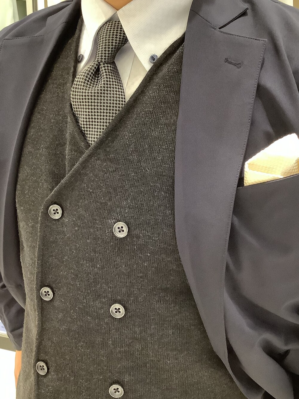 グレー系のベスト、ブルー系のビジネスシャツ、その他のネクタイを着用したメンズの秋コーディネートの3枚目の写真