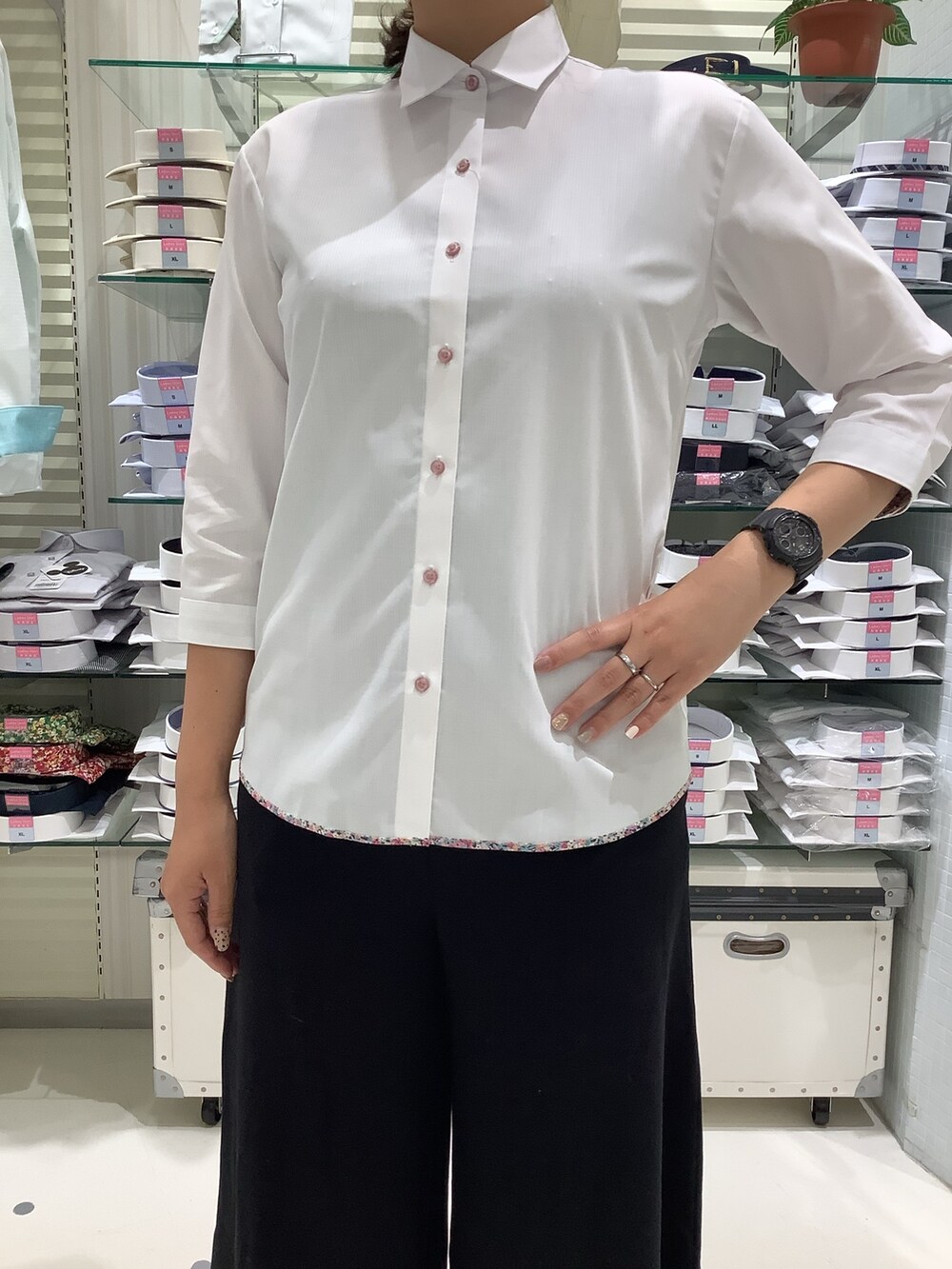 ホワイト系のビジネスシャツを着用したレディースの春コーディネートの2枚目の写真