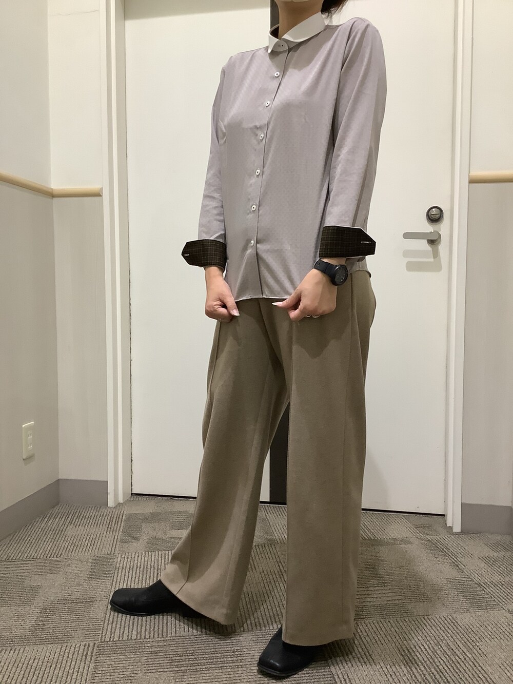 ブラウン系のビジネスシャツ、グレー系のベストを着用したレディースの秋コーディネートの4枚目の写真