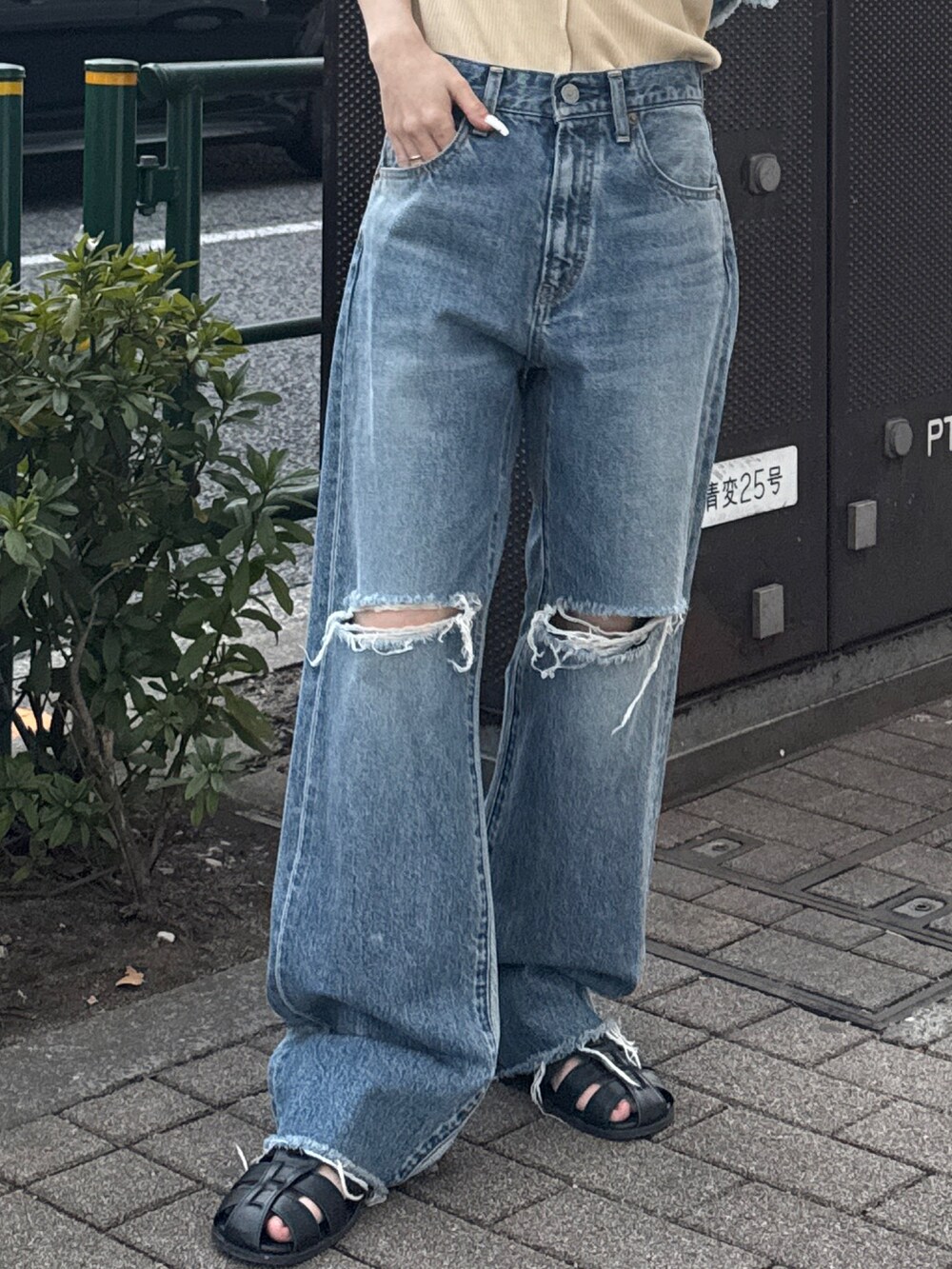 ブルー系のキャミソール、ホワイト系のタンクトップ、ブルー系のデニムパンツを着用したレディースの春コーディネートの6枚目の写真