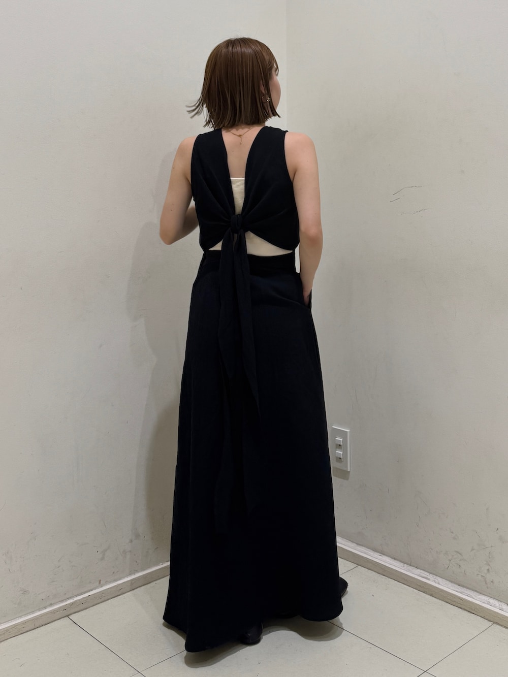 ホワイト系のキャミソール、ブラック系のワンピースを着用したレディースの夏コーディネートの3枚目の写真