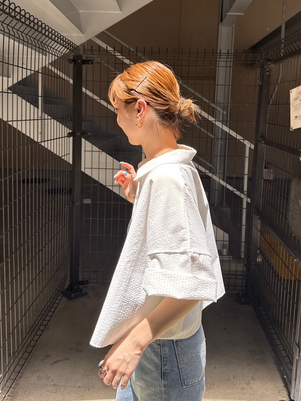 ホワイト系のシャツ/ブラウス、ブラック系のキャミソール、ブルー系のデニムパンツを着用したレディースの夏コーディネートの5枚目の写真