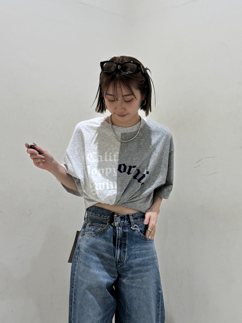 ブルー系のデニムパンツ、グレー系のTシャツ/カットソー、シルバー系のネックレスを着用したレディースの春コーディネートの4枚目の写真