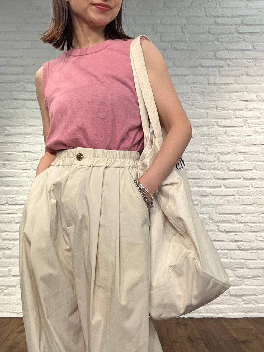 ピンク系のタンクトップ、ホワイト系のその他パンツ、ブラック系のサンダルを着用したレディースの春コーディネートの4枚目の写真