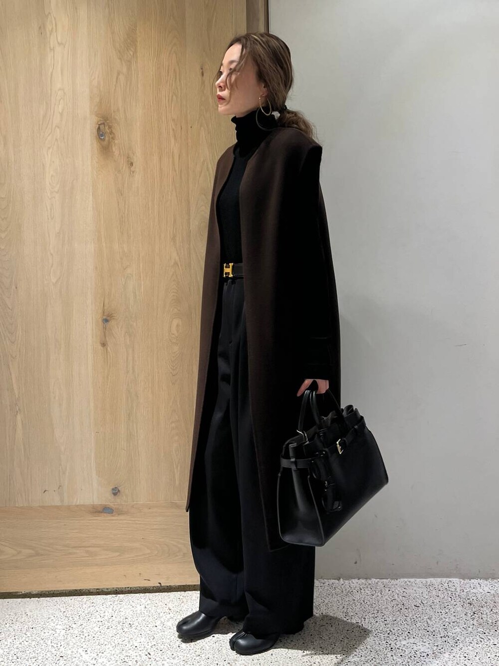 ブラウン系のベスト、ブラック系のニット/セーター、ブラック系のその他パンツを着用したレディースの冬コーディネートの2枚目の写真