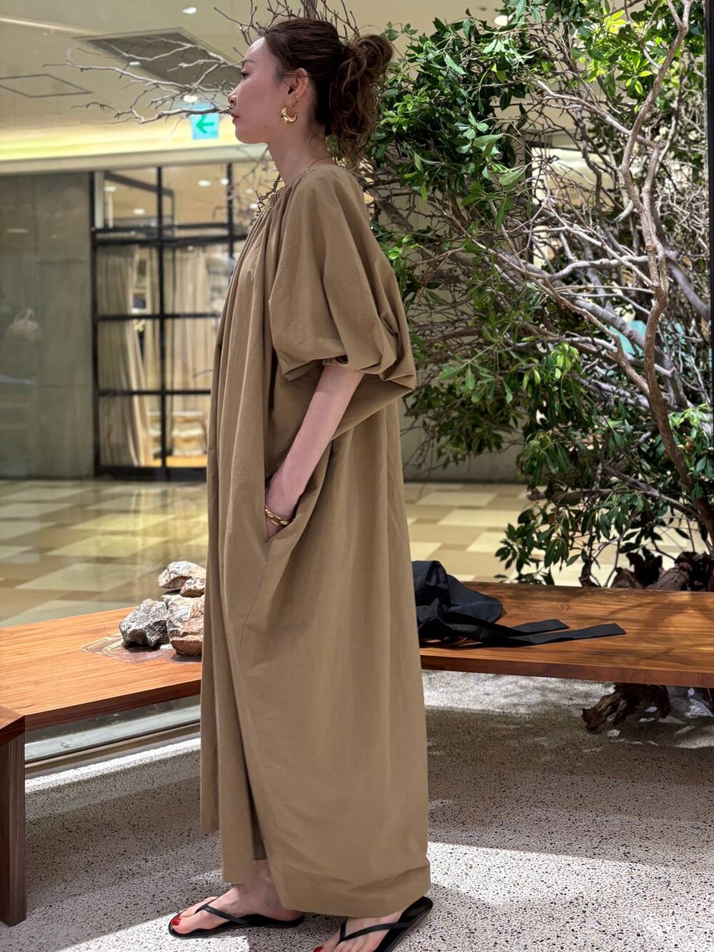 ベージュ系のワンピース、ゴールド系のピアス（両耳用）を着用したレディースの夏コーディネートの2枚目の写真