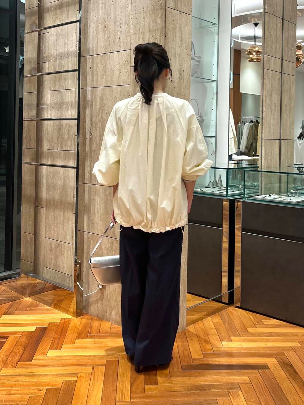 ホワイト系のブルゾン、ブルー系のその他パンツ、ブラック系のTシャツ/カットソーを着用したレディースの春コーディネートの3枚目の写真