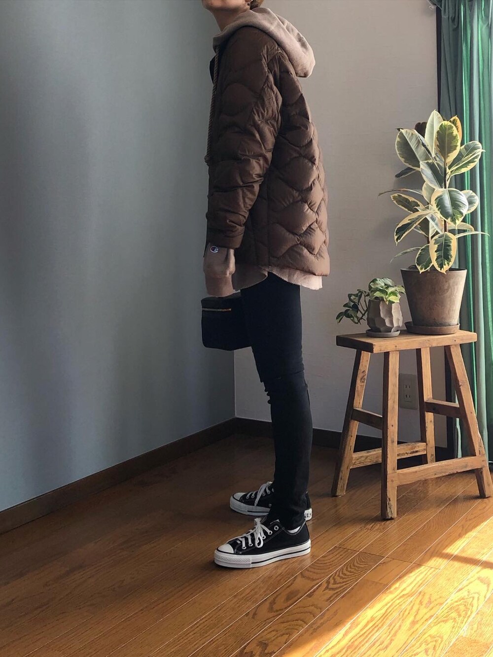 ブラウン系のダウンジャケット/コート、ホワイト系のスウェットパンツ、ブラウン系のスニーカーを着用したレディースの秋コーディネートの2枚目の写真