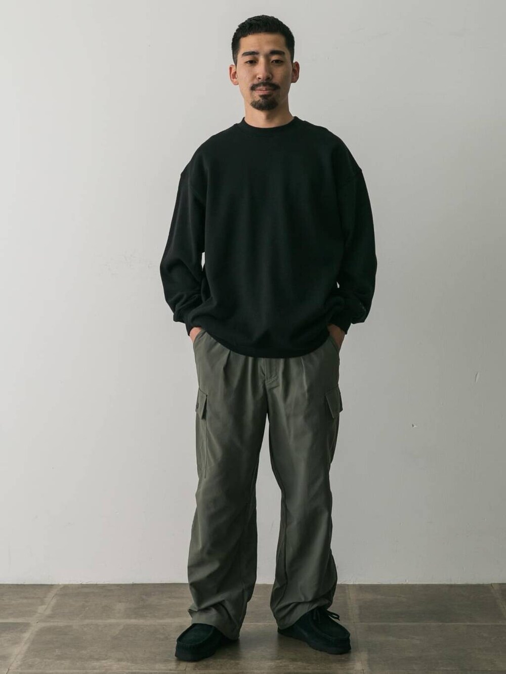 グリーン系のその他パンツ、ブラック系のスウェットを着用したメンズの秋コーディネートの2枚目の写真