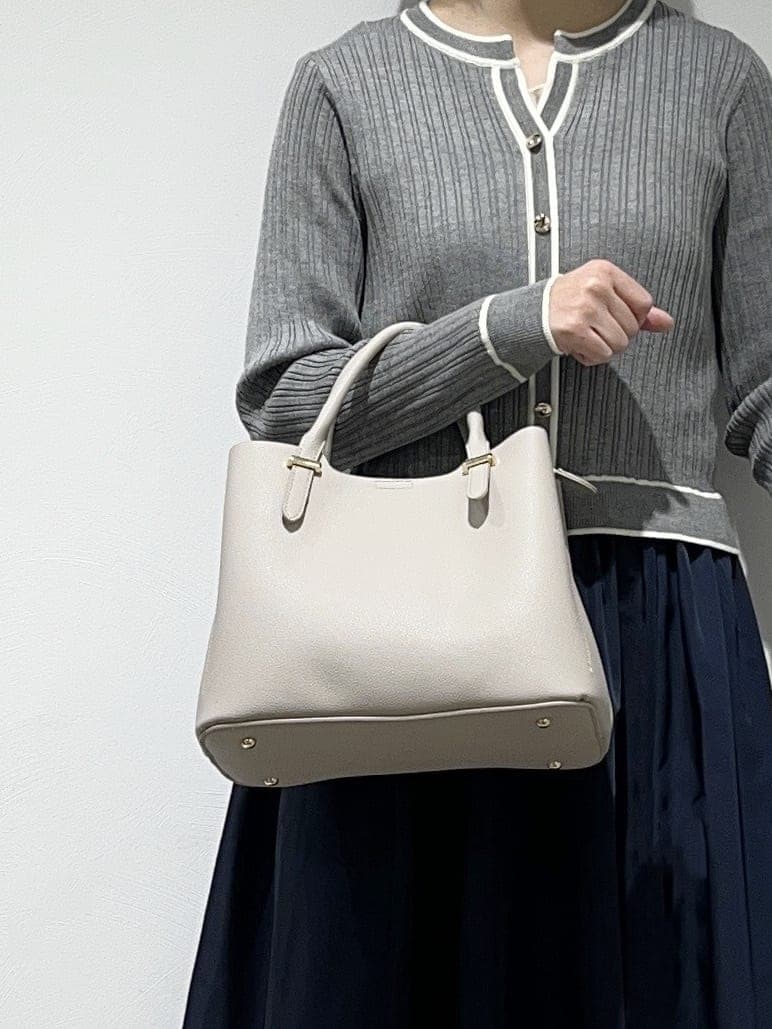 グレー系のワンピース、ホワイト系のタンクトップ、グレー系のトートバッグを着用したレディースの春コーディネートの4枚目の写真