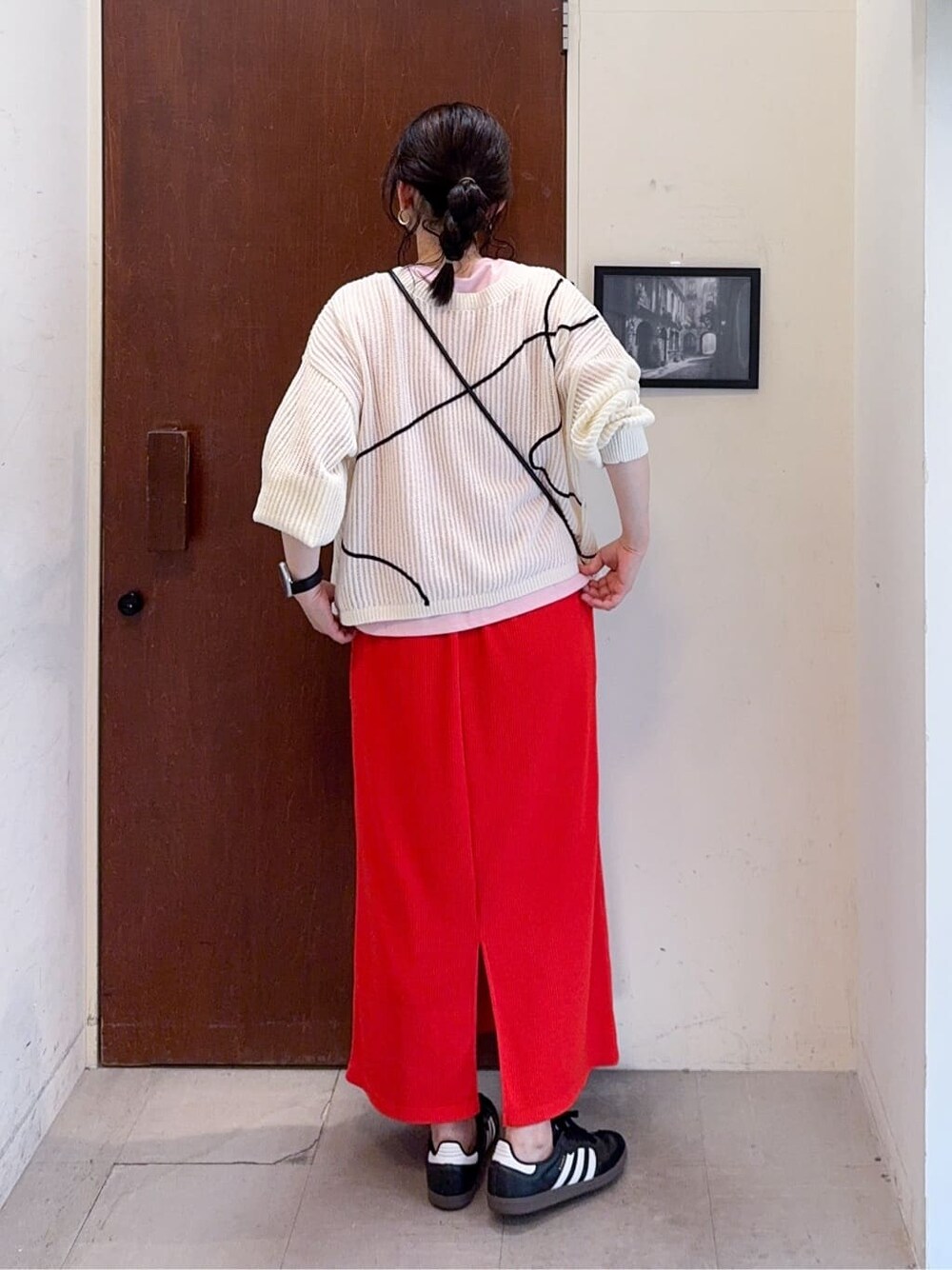 ホワイト系のカーディガン/ボレロ、ピンク系のTシャツ/カットソー、オレンジ系のスカートを着用したレディースの春コーディネートの4枚目の写真