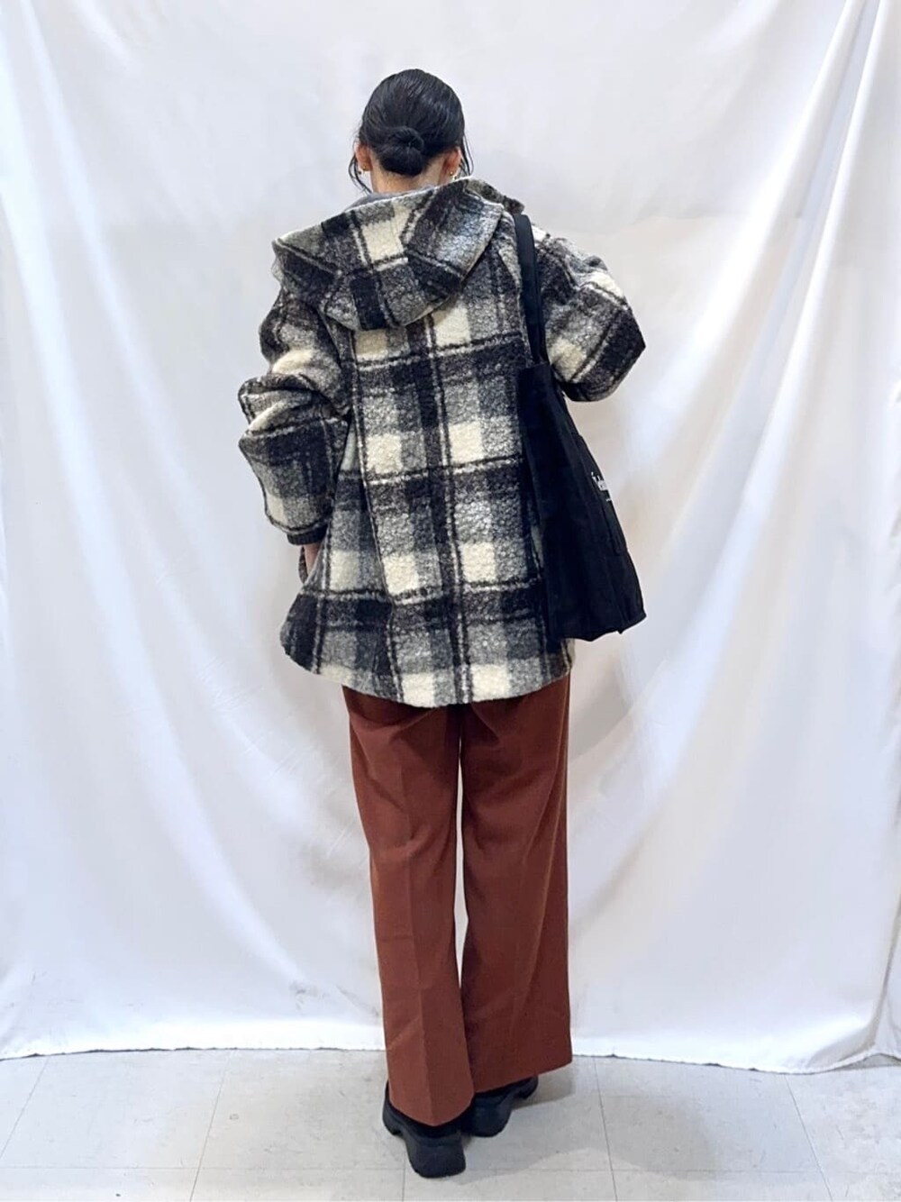 ブラック系のその他アウター、グレー系のニット/セーター、レッド系のその他パンツを着用したレディースの冬コーディネートの4枚目の写真