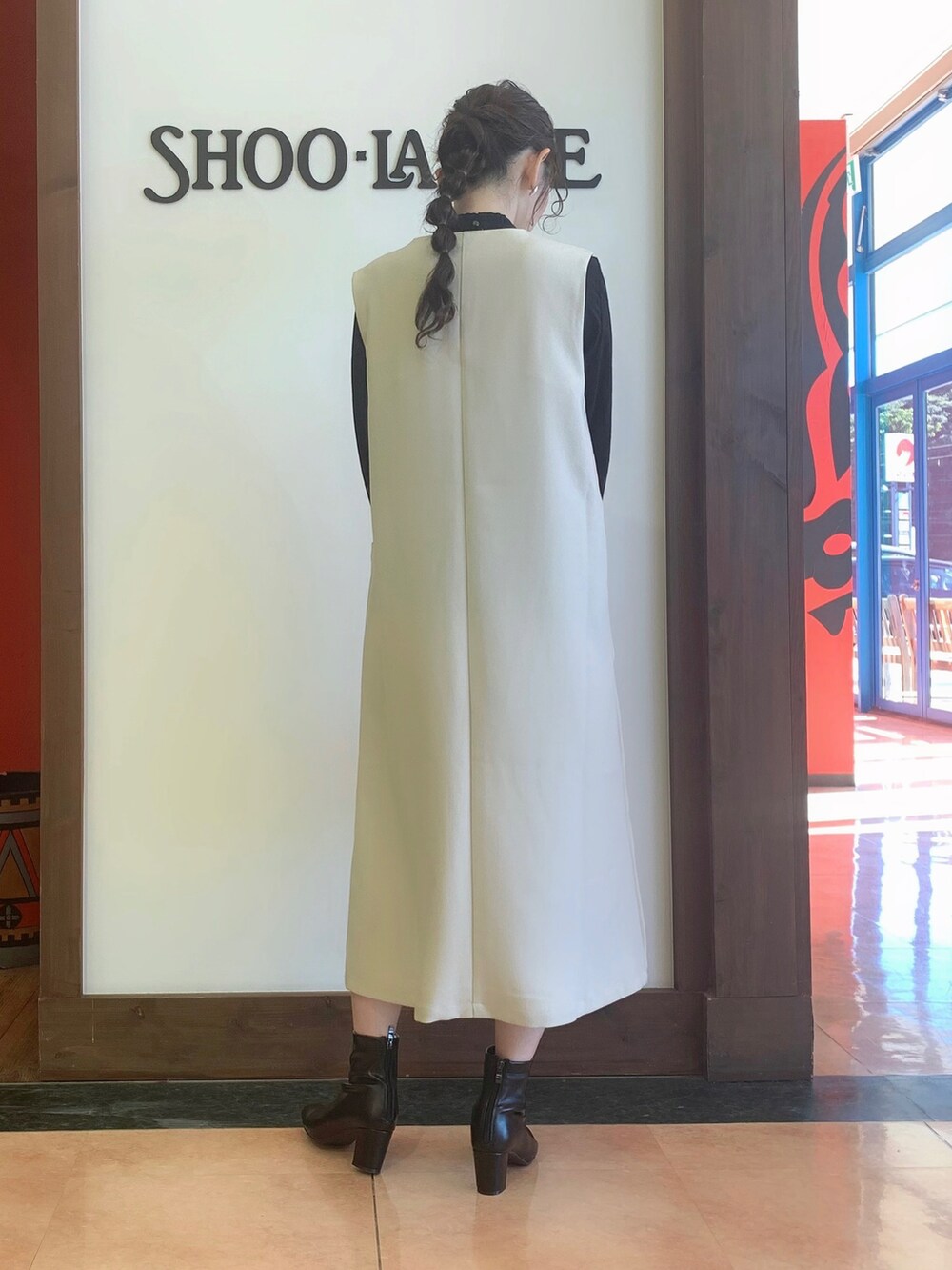 ブラック系のワンピース、ブラック系のシャツ/ブラウス、ブラック系のトートバッグを着用したレディースの冬コーディネートの4枚目の写真