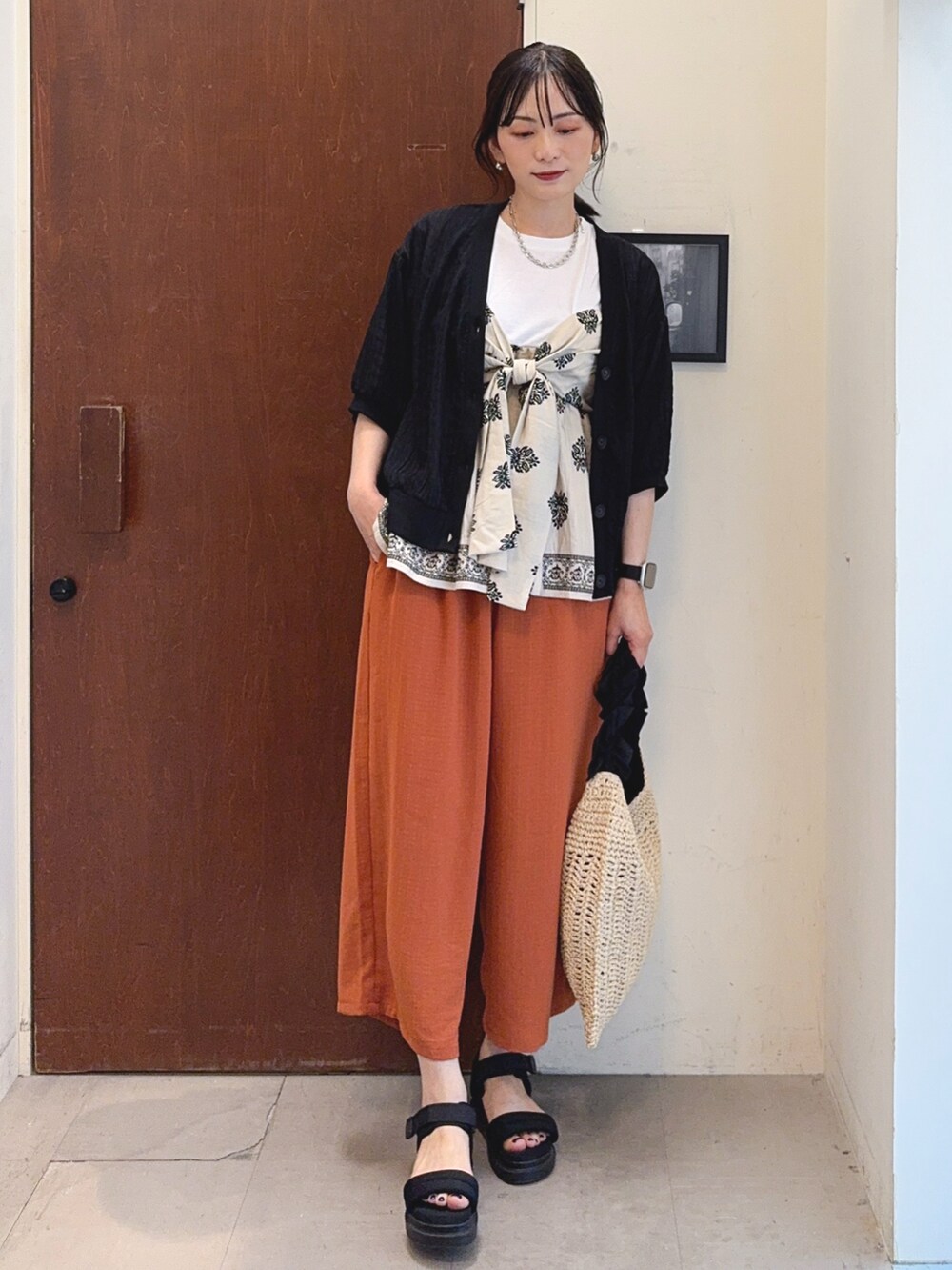 ベージュ系のTシャツ/カットソー、オレンジ系のその他パンツ、ブラック系のトートバッグを着用したレディースの夏コーディネートの2枚目の写真