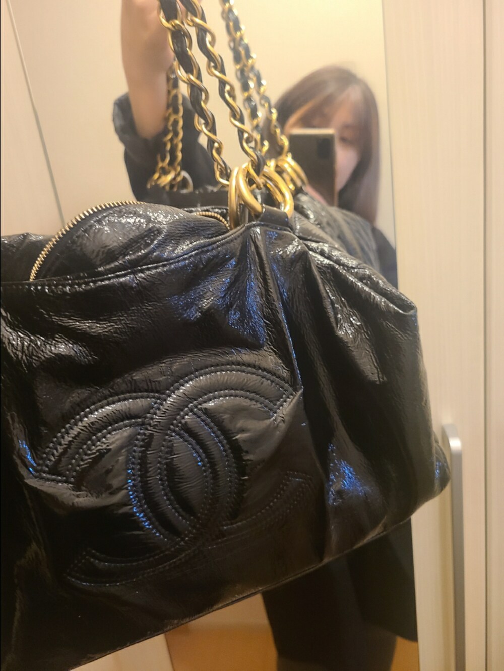 ブラック系のハンドバッグ、ブラック系のローファーを着用したレディースの秋コーディネートの2枚目の写真