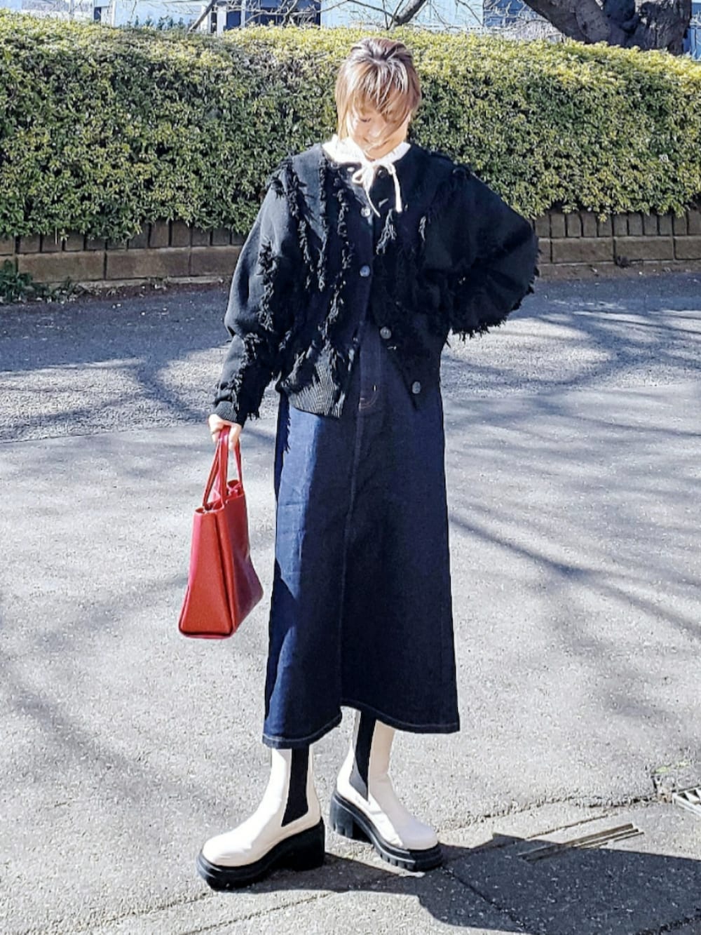 ブルー系のデニムスカート、ホワイト系のシャツ/ブラウス、レッド系のトートバッグを着用したレディースの冬コーディネートの2枚目の写真