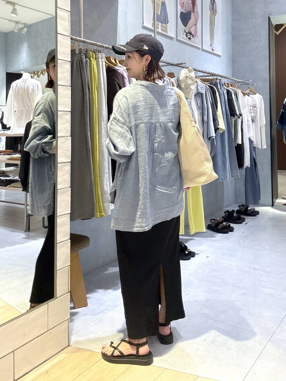 ブラウン系のサンダル、ブルー系のシャツ/ブラウス、ホワイト系のショルダーバッグを着用したレディースの春コーディネートの3枚目の写真