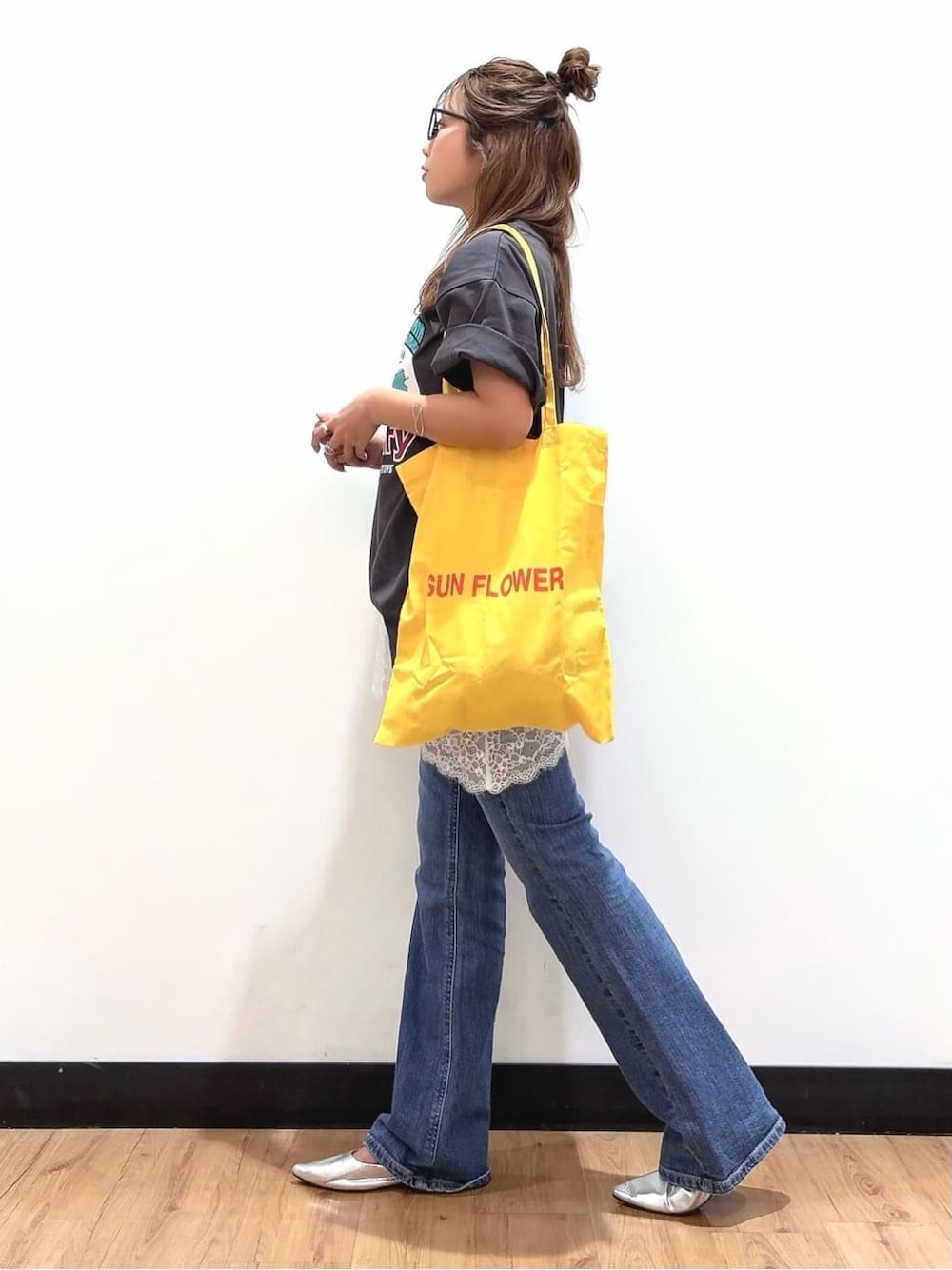 グレー系のTシャツ/カットソー、ブルー系のデニムパンツ、イエロー系のその他を着用したレディースの春コーディネートの2枚目の写真
