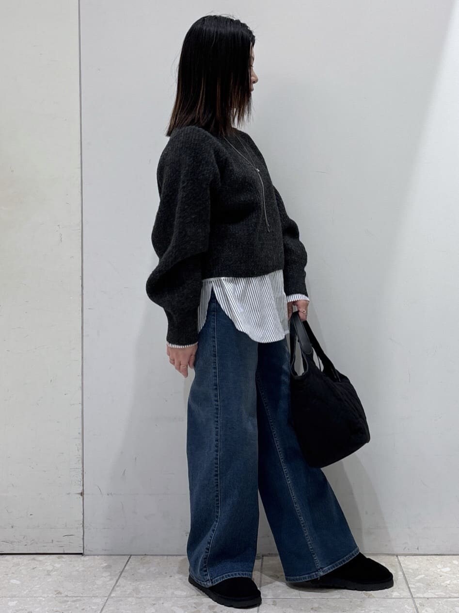 グレー系のニット/セーター、ホワイト系のTシャツ/カットソー、ブルー系のデニムパンツを着用したレディースの冬コーディネートの2枚目の写真