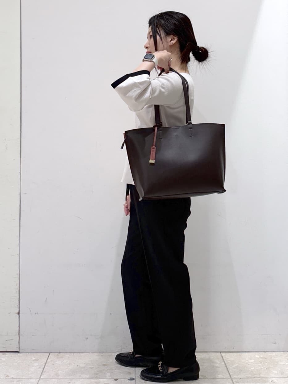グレー系のニット/セーター、ブラック系のその他パンツ、ブラウン系のトートバッグを着用したレディースの秋コーディネートの7枚目の写真