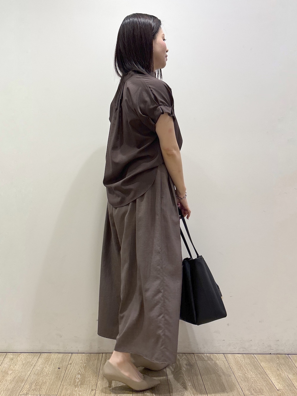 ブラウン系のシャツ/ブラウス、ブラウン系のその他パンツ、ブラック系のトートバッグを着用したレディースの夏コーディネートの2枚目の写真