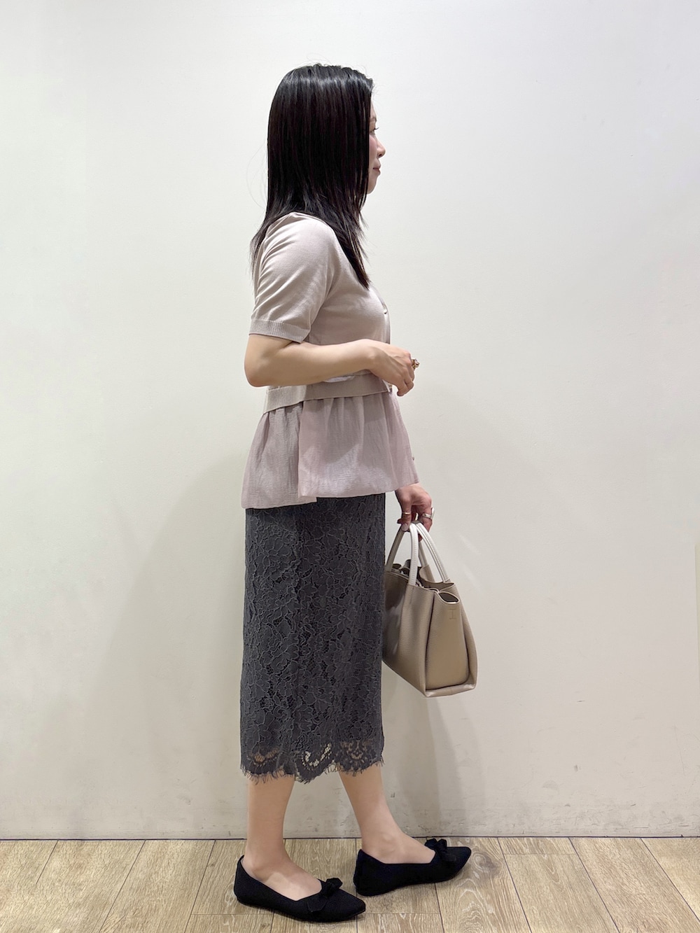ベージュ系のカーディガン/ボレロ、グレー系のスカート、ベージュ系のトートバッグを着用したレディースの夏コーディネートの2枚目の写真