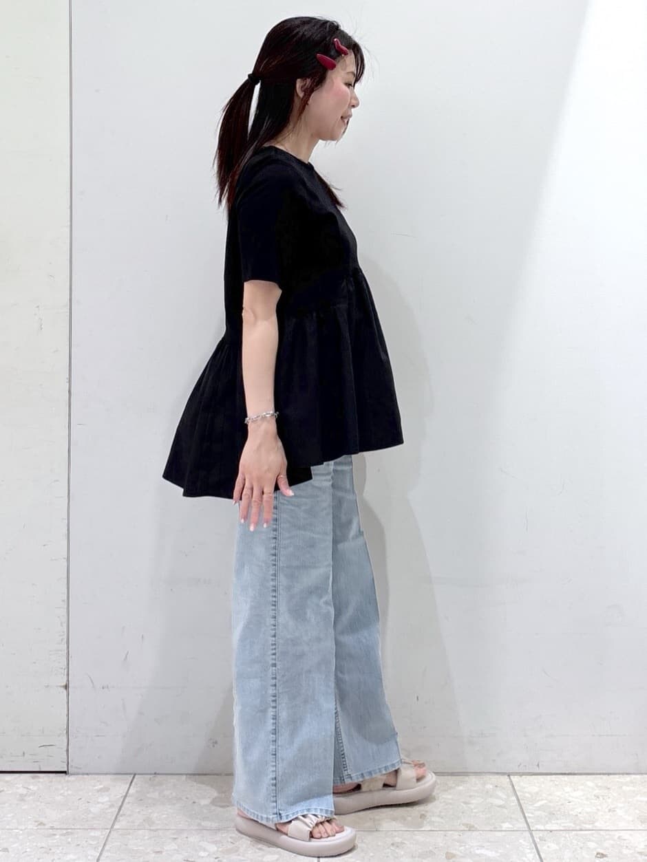ブラック系のTシャツ/カットソー、ブルー系のデニムパンツ、ベージュ系のサンダルを着用したレディースの春コーディネートの2枚目の写真