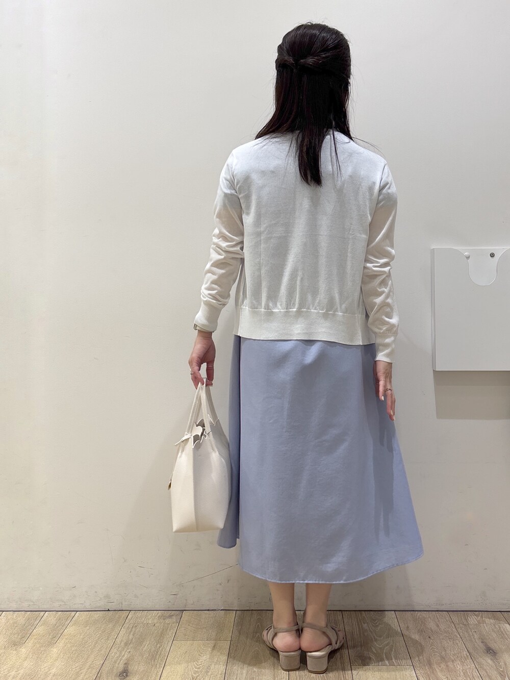 ベージュ系のサンダル、ブルー系のワンピース、ホワイト系のトートバッグを着用したレディースの春コーディネートの7枚目の写真