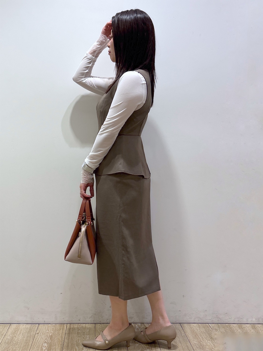 ホワイト系のTシャツ/カットソー、ブラウン系のワンピース、レッド系のボストンバッグを着用したレディースの秋コーディネートの4枚目の写真
