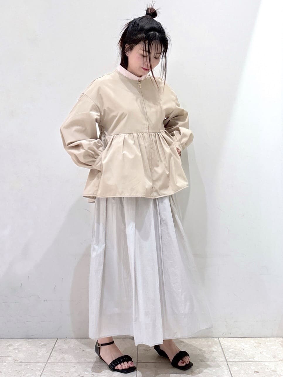 ベージュ系のノーカラージャケット、ピンク系のシャツ/ブラウス、グレー系のスカートを着用したレディースの春コーディネートの7枚目の写真