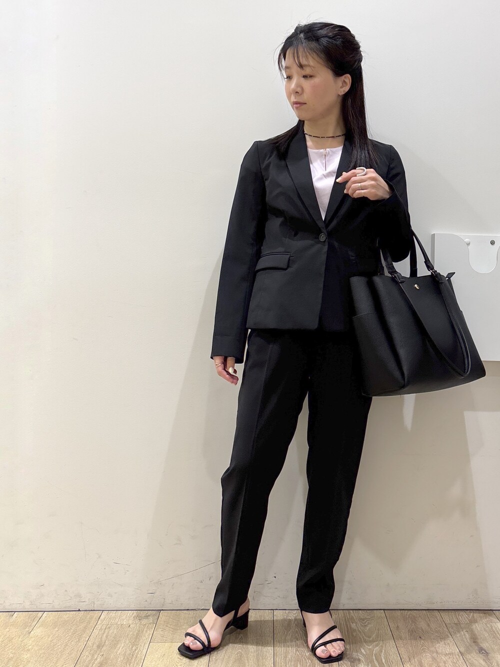 ブラック系のテーラードジャケット、ピンク系のTシャツ/カットソー、ブラック系のその他パンツを着用したレディースの春コーディネートの5枚目の写真