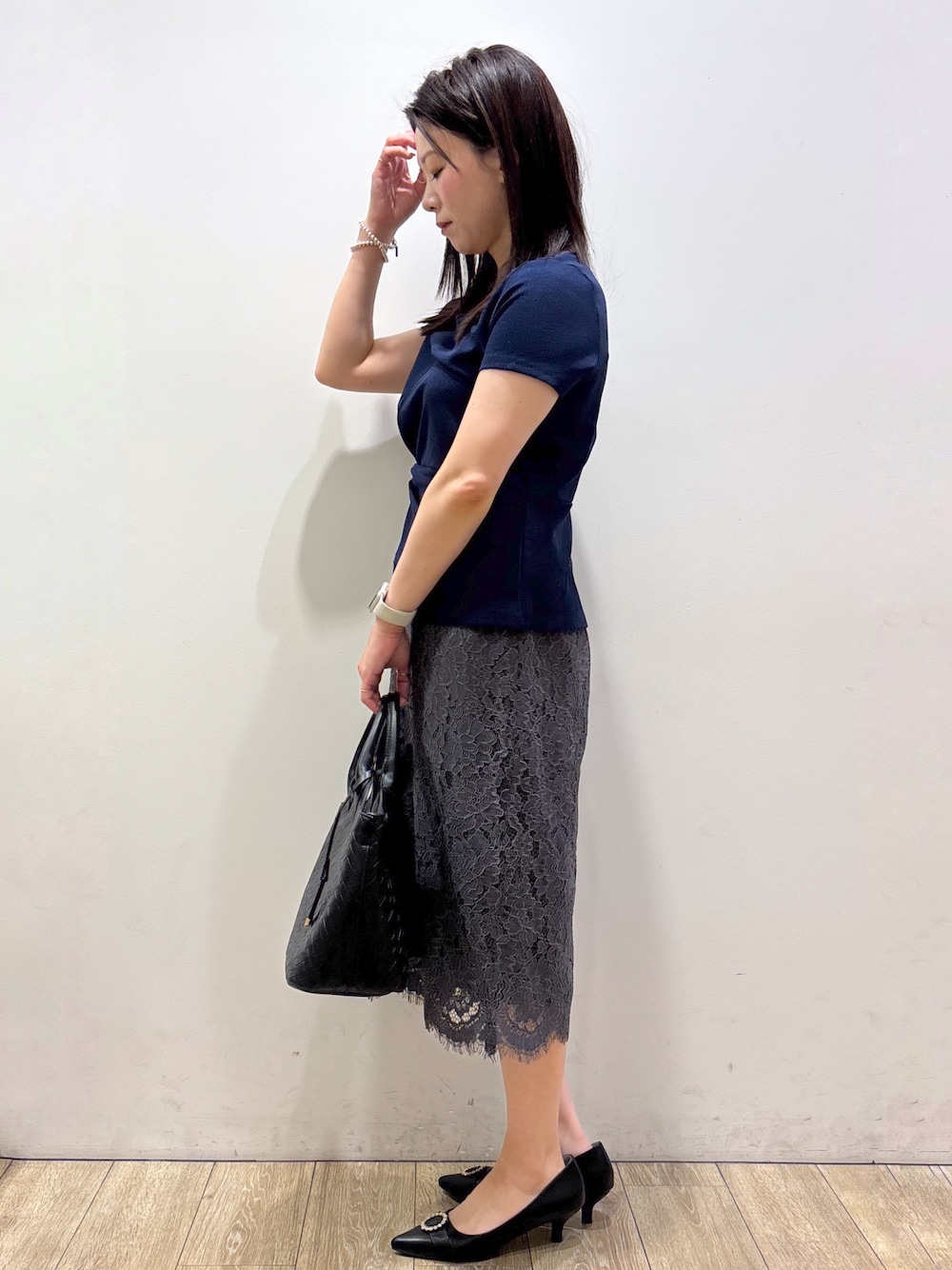 ブルー系のTシャツ/カットソー、グレー系のスカート、ブラック系のトートバッグを着用したレディースの夏コーディネートの4枚目の写真