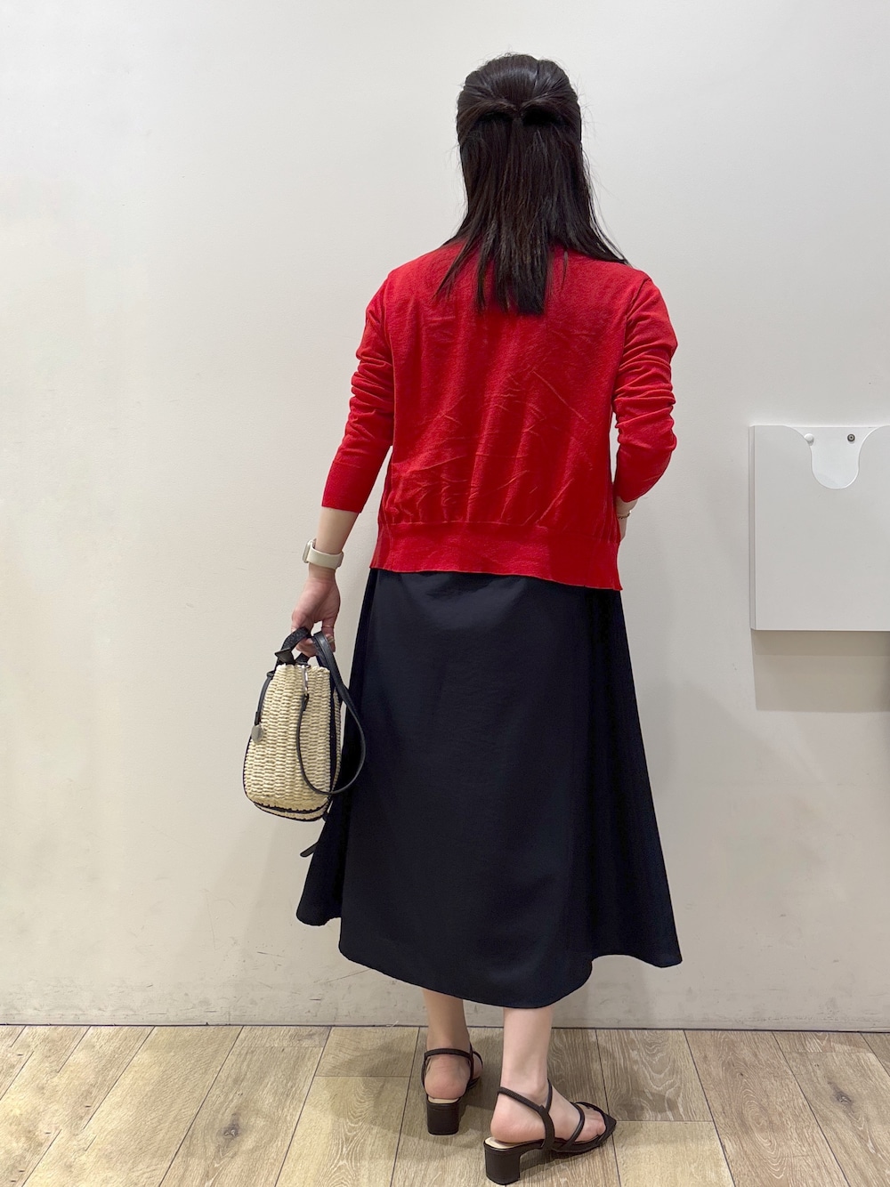 ブラック系のトートバッグ、ブラウン系のサンダル、ブルー系のワンピースを着用したレディースの春コーディネートの3枚目の写真