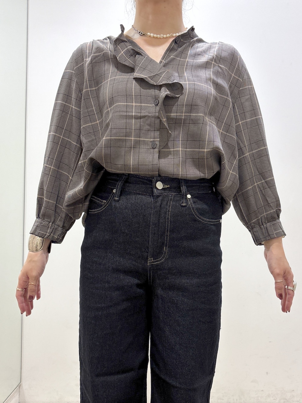 グレー系のシャツ/ブラウス、ブルー系のデニムパンツ、ブラック系のトートバッグを着用したレディースの秋コーディネートの5枚目の写真