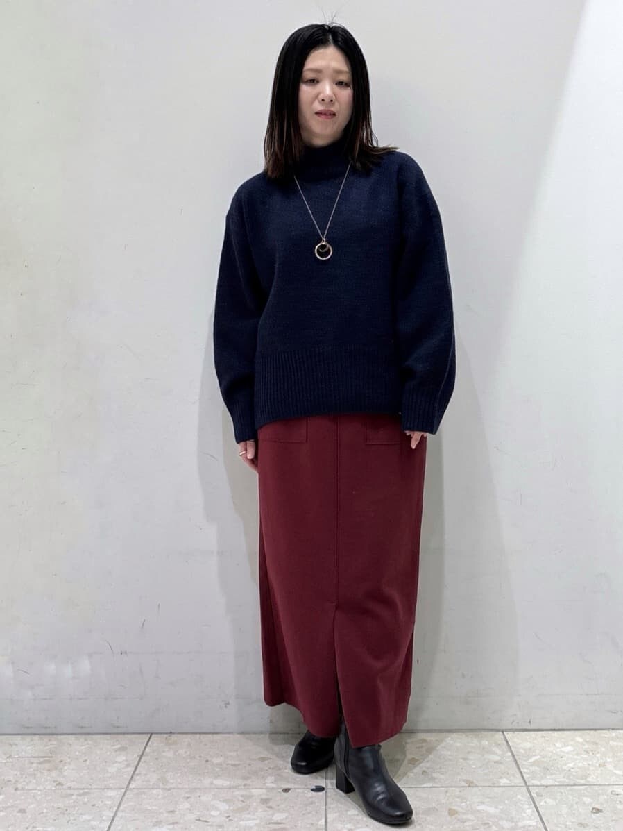 ブルー系のニット/セーター、レッド系のスカート、ブラック系のショルダーバッグを着用したレディースの冬コーディネートの5枚目の写真