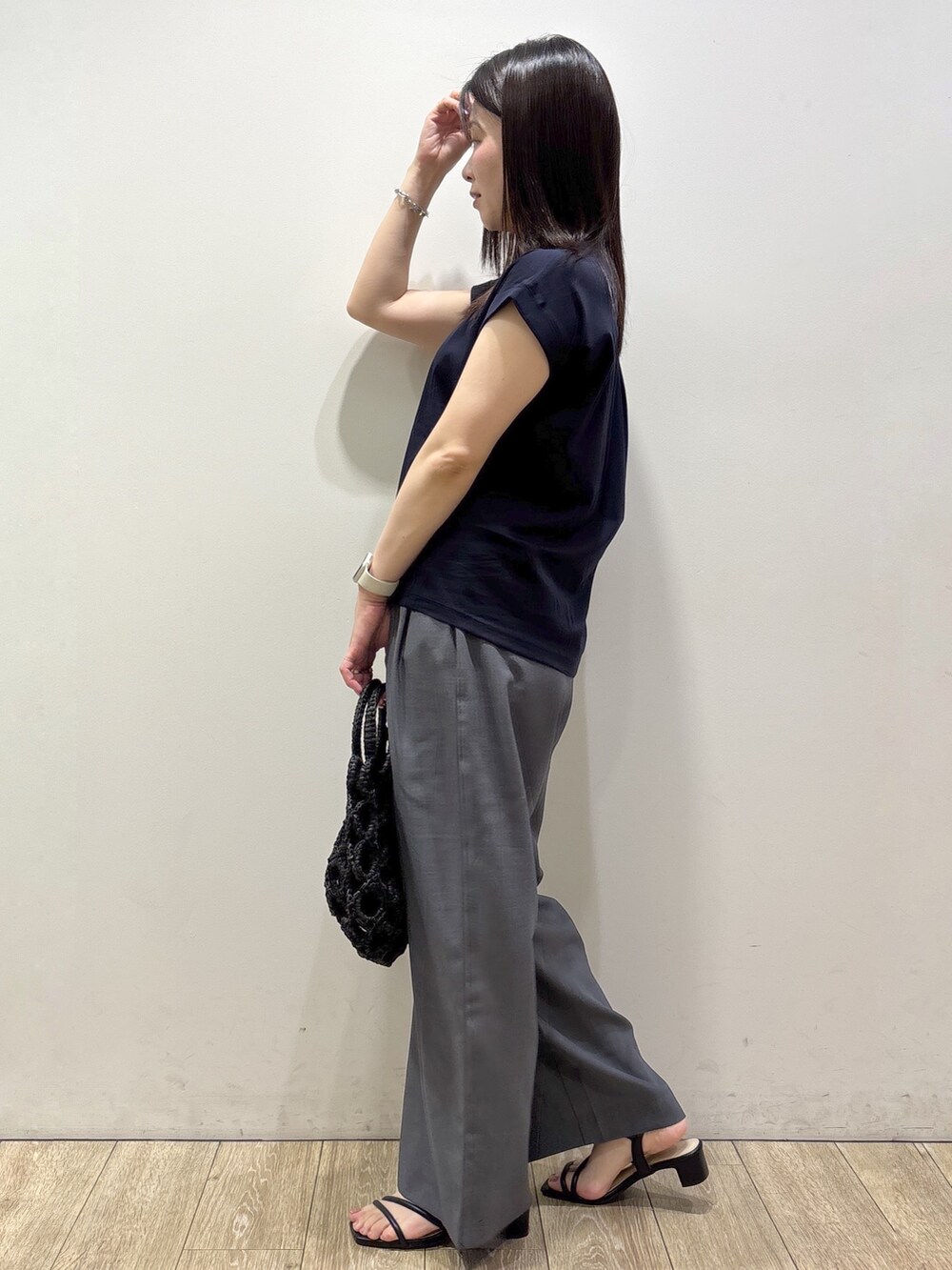 ブルー系のTシャツ/カットソー、グレー系のその他パンツ、ブラック系のハンドバッグを着用したレディースの夏コーディネートの10枚目の写真