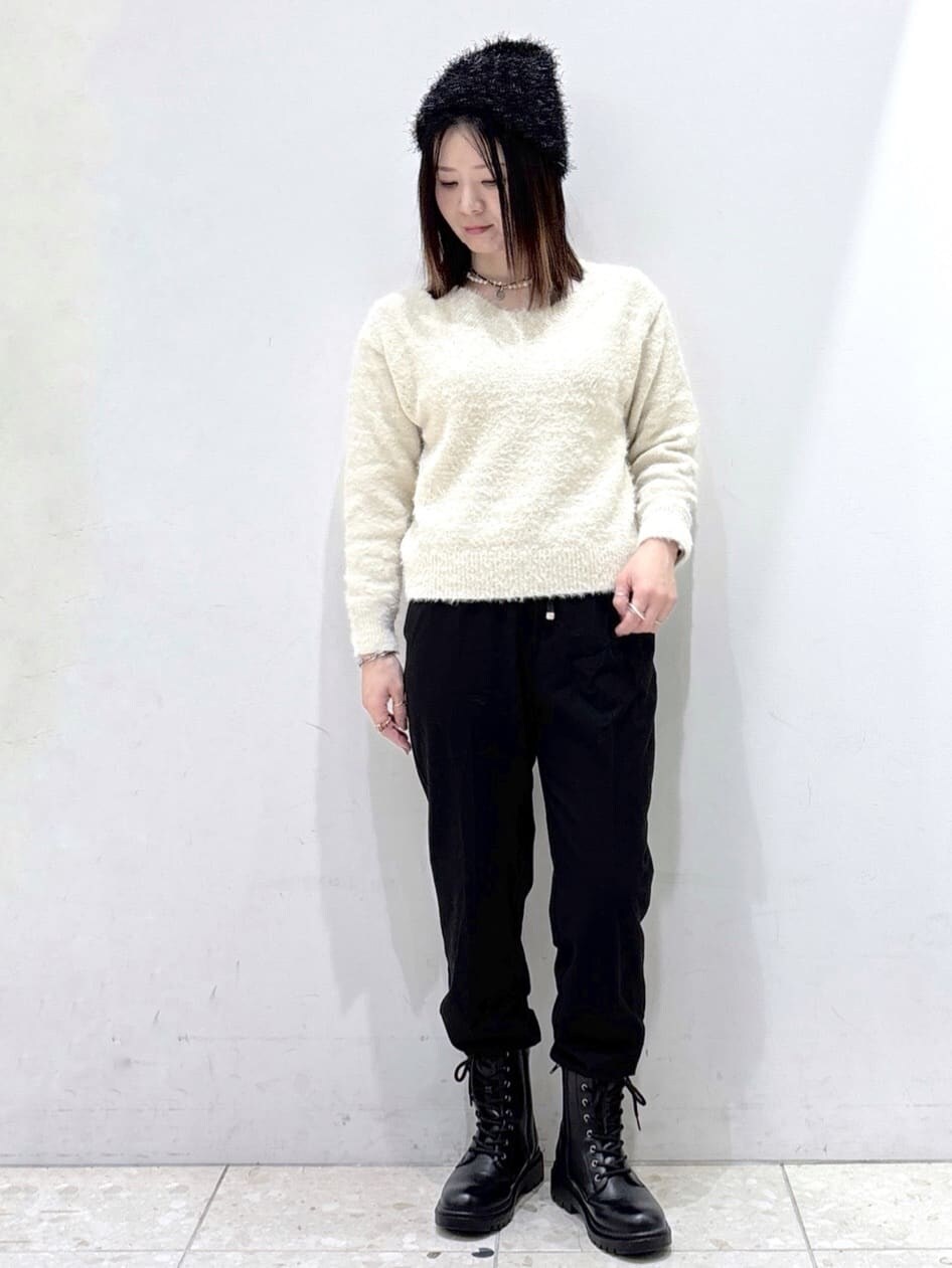 ホワイト系のダウンジャケット/コート、ベージュ系のニット/セーター、ブラック系のハンドバッグを着用したレディースの冬コーディネートの7枚目の写真