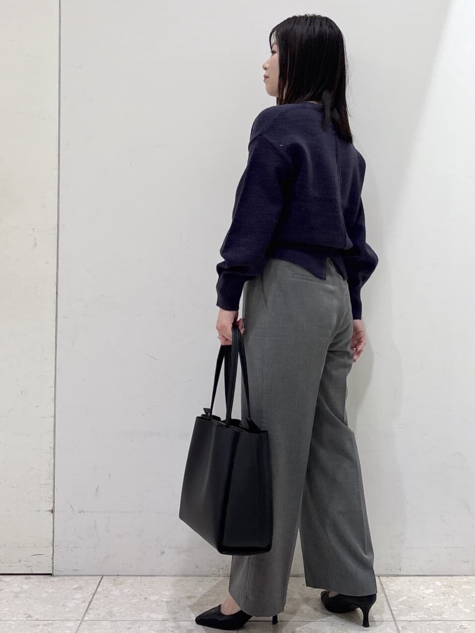 ブラック系のステンカラーコート、ブルー系のニット/セーター、グレー系のその他パンツを着用したレディースの冬コーディネートの8枚目の写真