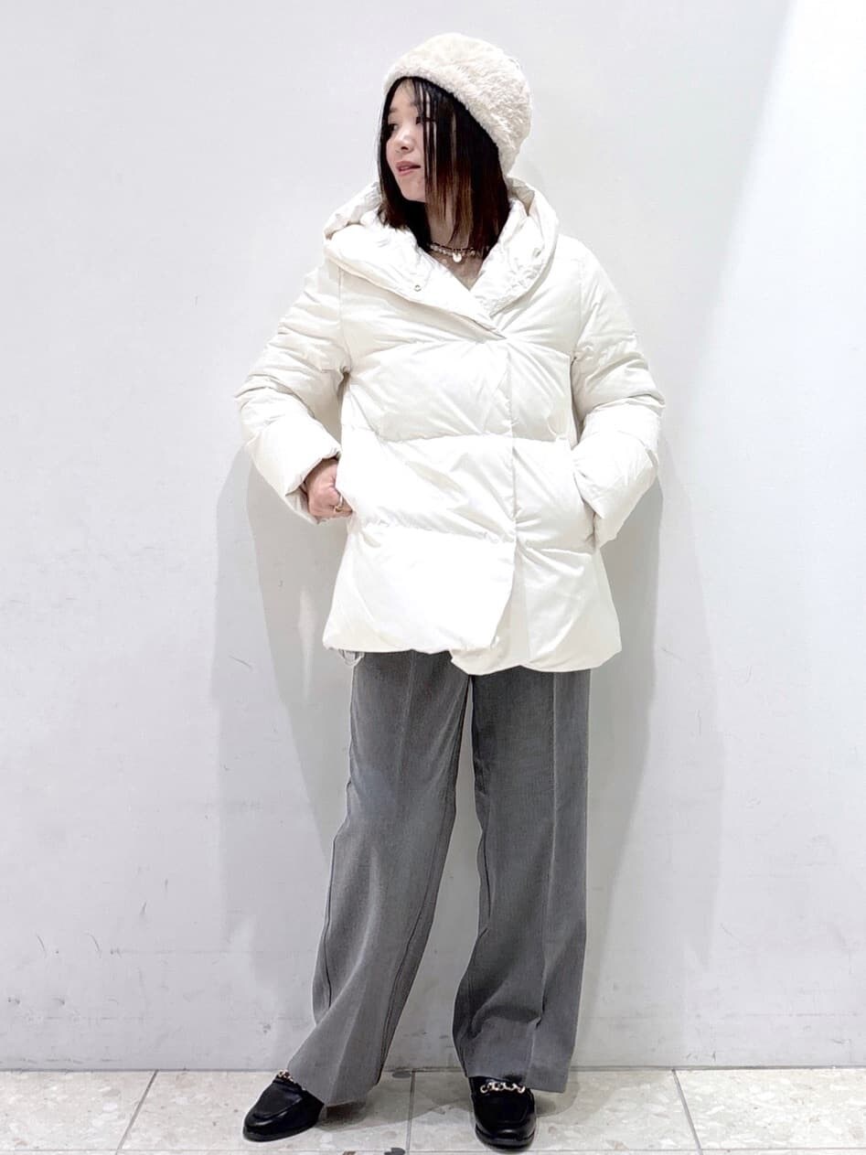 ホワイト系のダウンジャケット/コート、ベージュ系のニット/セーター、グレー系のその他パンツを着用したレディースの冬コーディネートの7枚目の写真