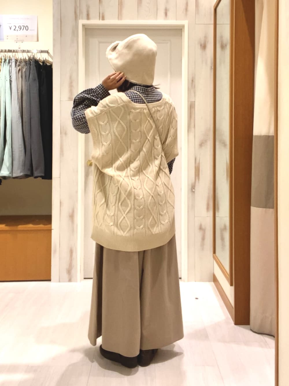 ブラック系のシャツ/ブラウス、ホワイト系のベスト、ホワイト系のハンドバッグを着用したレディースの秋コーディネートの2枚目の写真