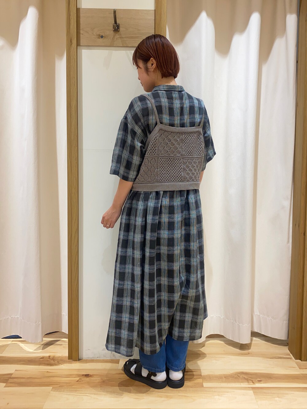 ブルー系のデニムパンツ、ブラック系のサンダルを着用したレディースの春コーディネートの3枚目の写真