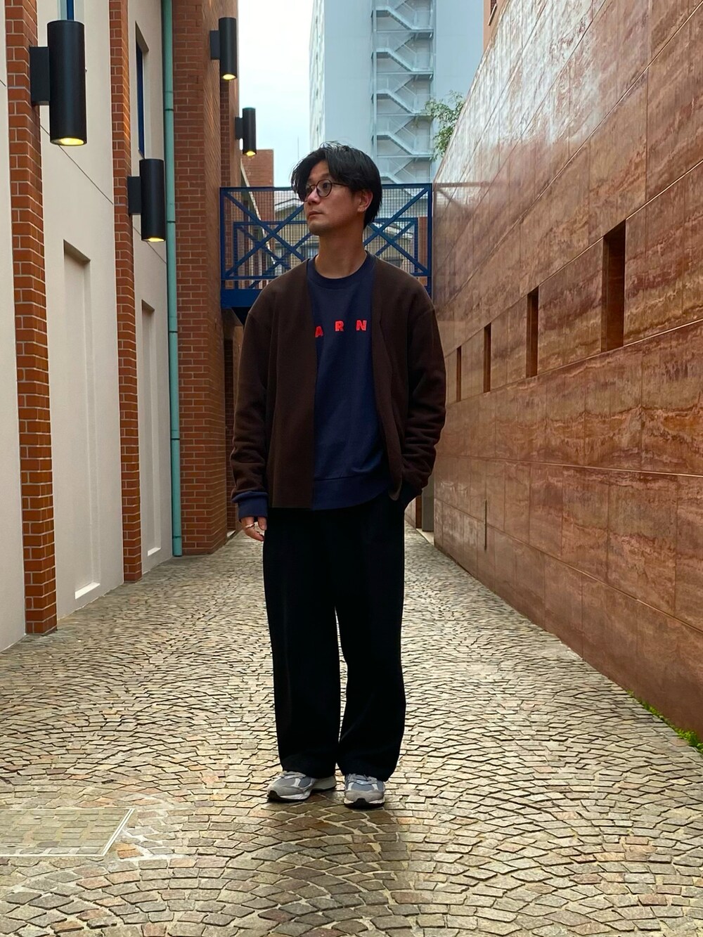 ブラック系のブルゾン、グレー系のスニーカー、ブルー系のスウェットを着用したメンズの春コーディネートの2枚目の写真