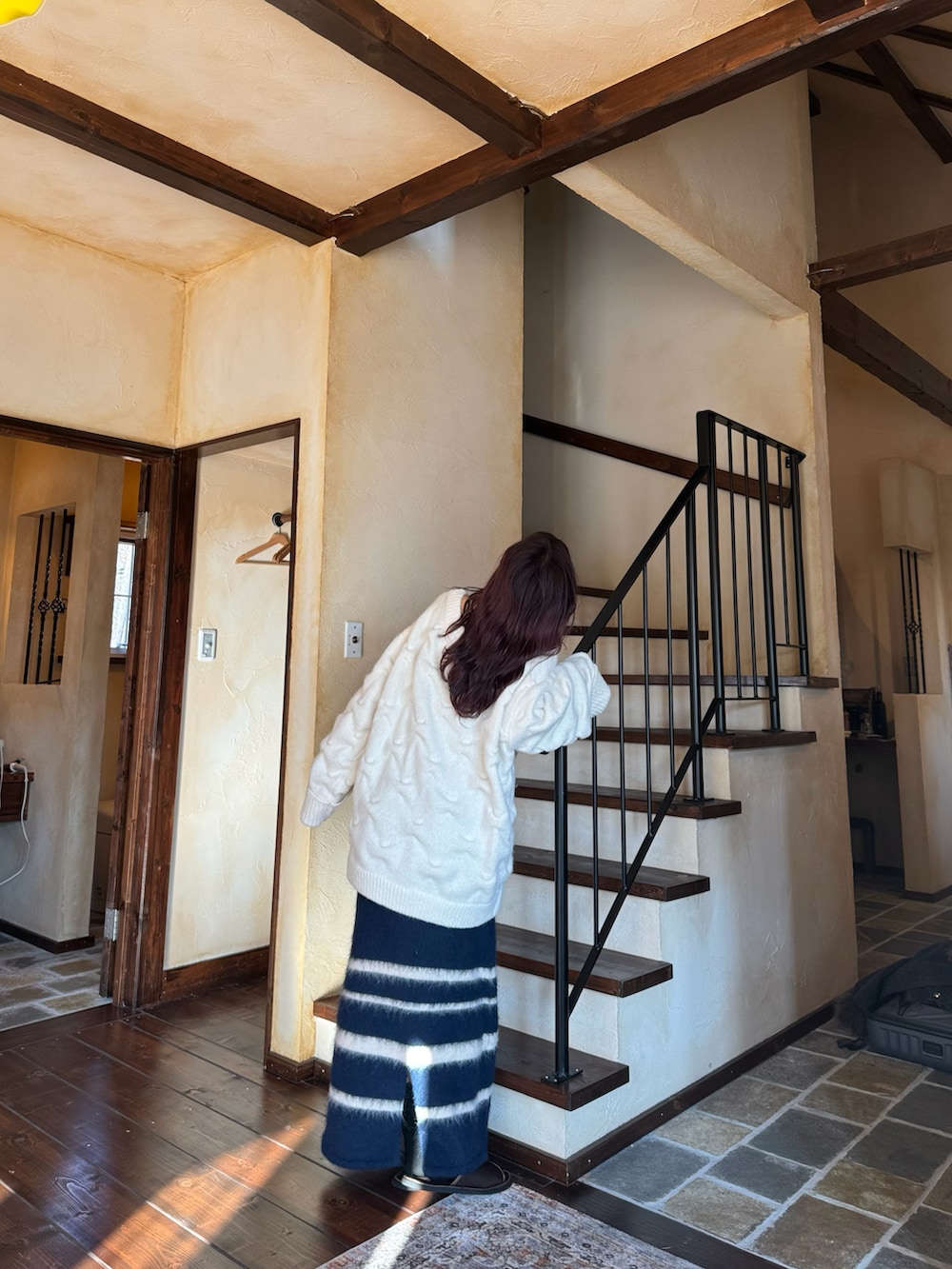 ホワイト系のニット/セーター、ブルー系のスカートを着用したレディースの冬コーディネートの3枚目の写真