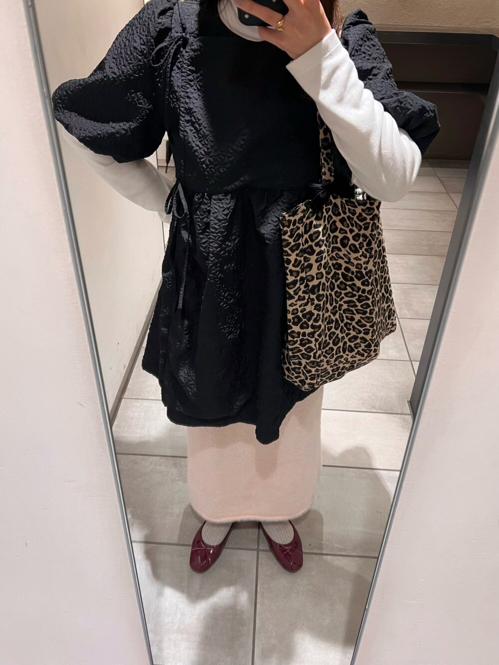 ブラック系のワンピース、ピンク系のスカート、レッド系のバレエシューズを着用したレディースの冬コーディネートの4枚目の写真