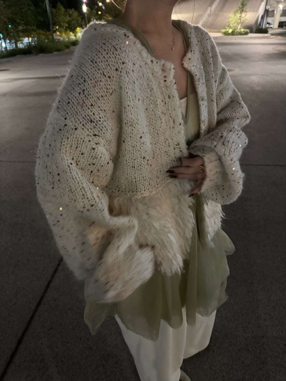 ベージュ系のショルダーバッグ、ベージュ系のサンダル、ホワイト系のスラックスを着用したレディースの秋コーディネートの4枚目の写真