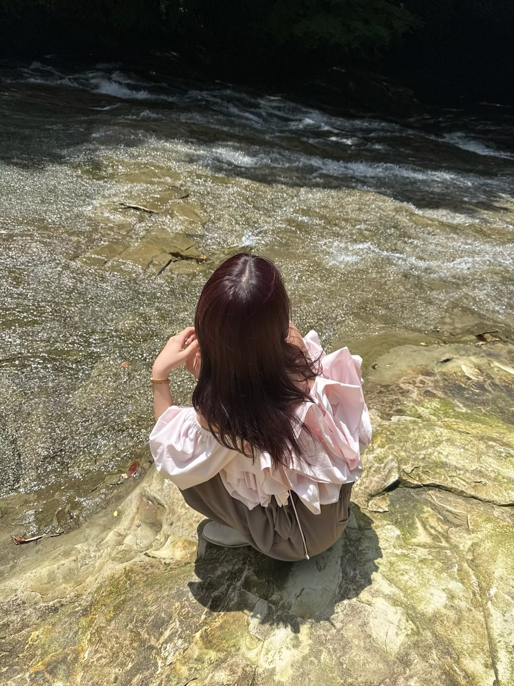 ベージュ系のハンドバッグ、ピンク系のシャツ/ブラウス、ブラウン系のパンツを着用したレディースの夏コーディネートの3枚目の写真