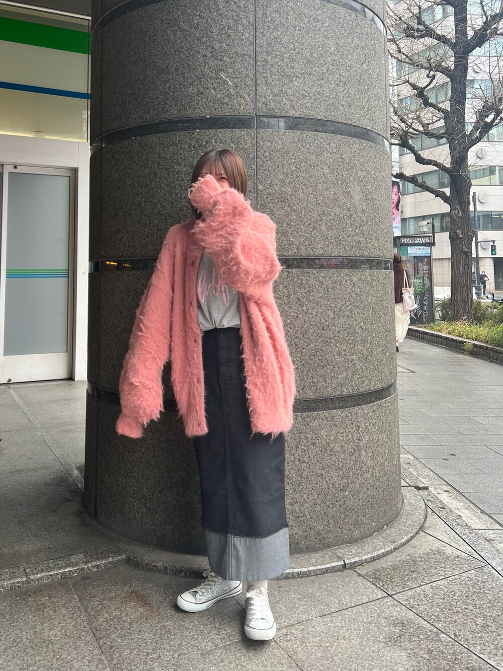 ピンク系のカーディガン/ボレロ、グレー系のTシャツ/カットソー、ブラック系のデニムスカートを着用したレディースの冬コーディネートの5枚目の写真